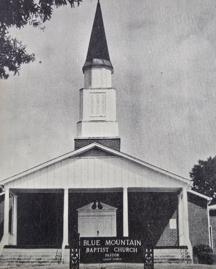 Blue Mountain Baptist Church with steeple and sign out front.