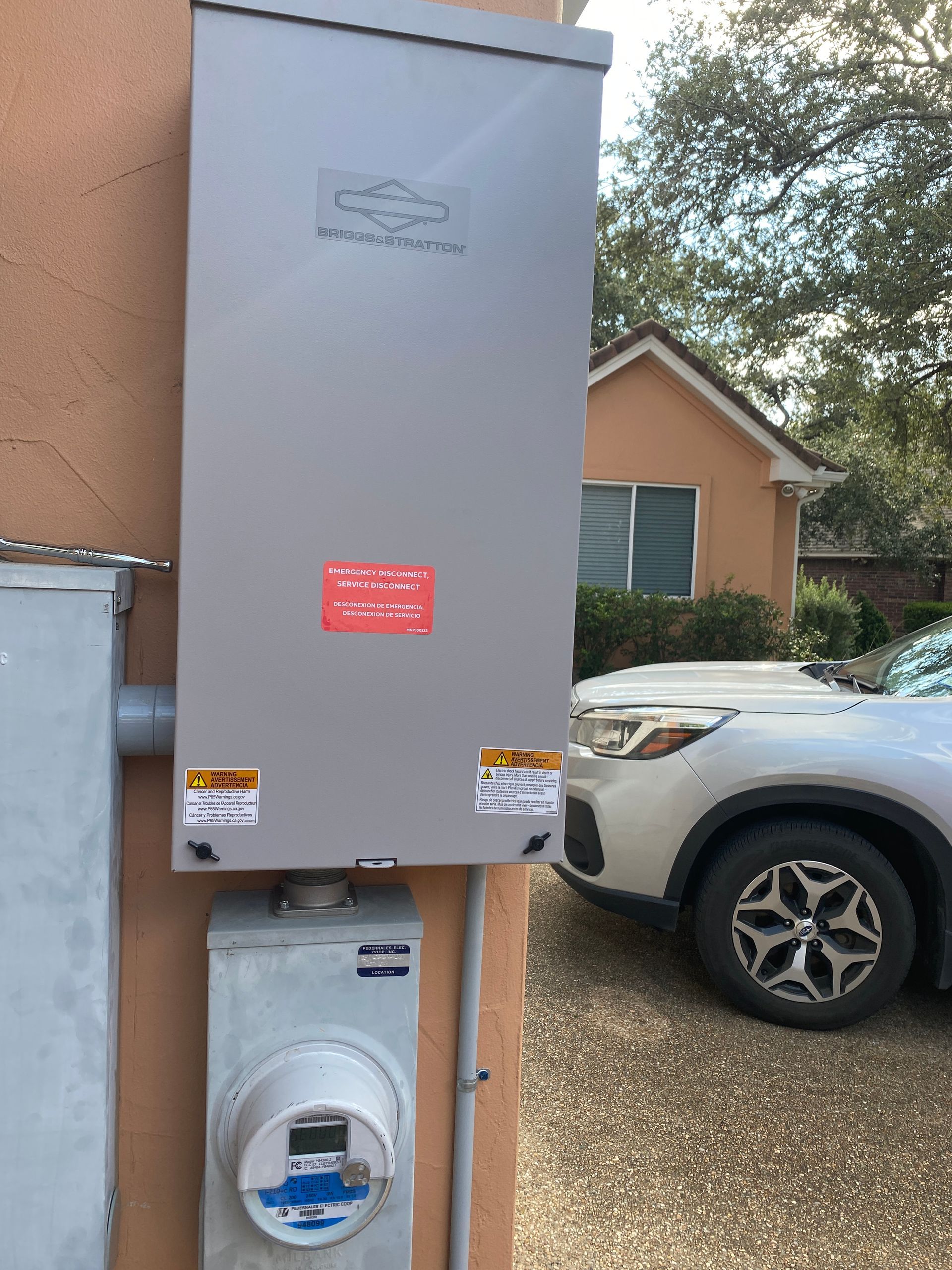 A white suv is parked in front of a building next to a meter.