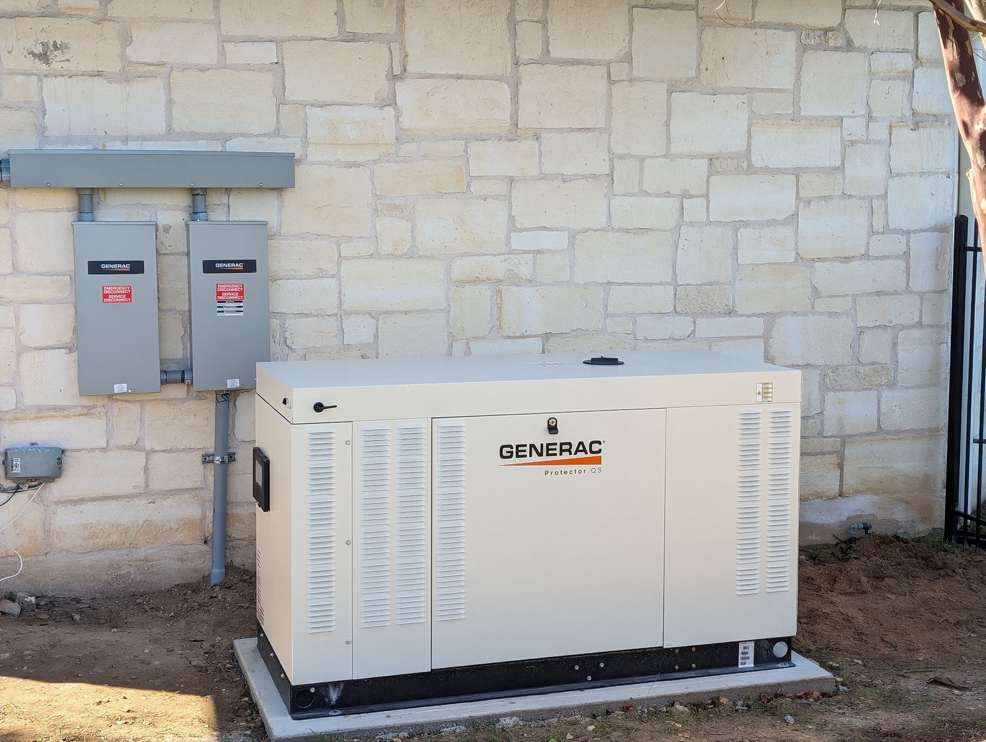 A generator is sitting in front of a brick wall