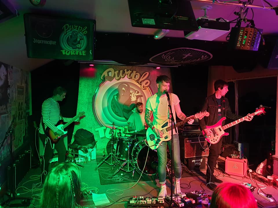 A group of people are playing instruments on a stage.