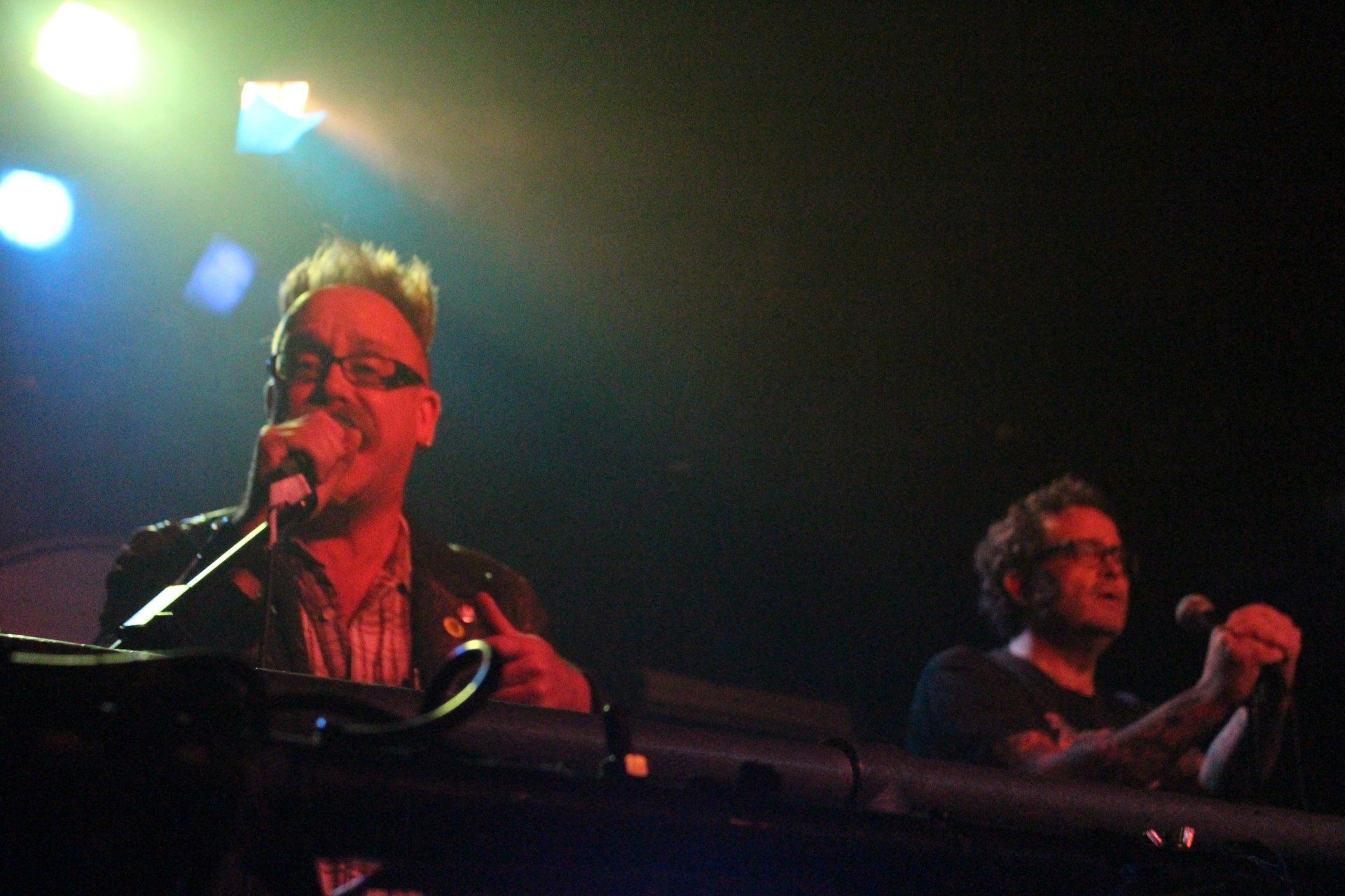 A man singing into a microphone on a stage