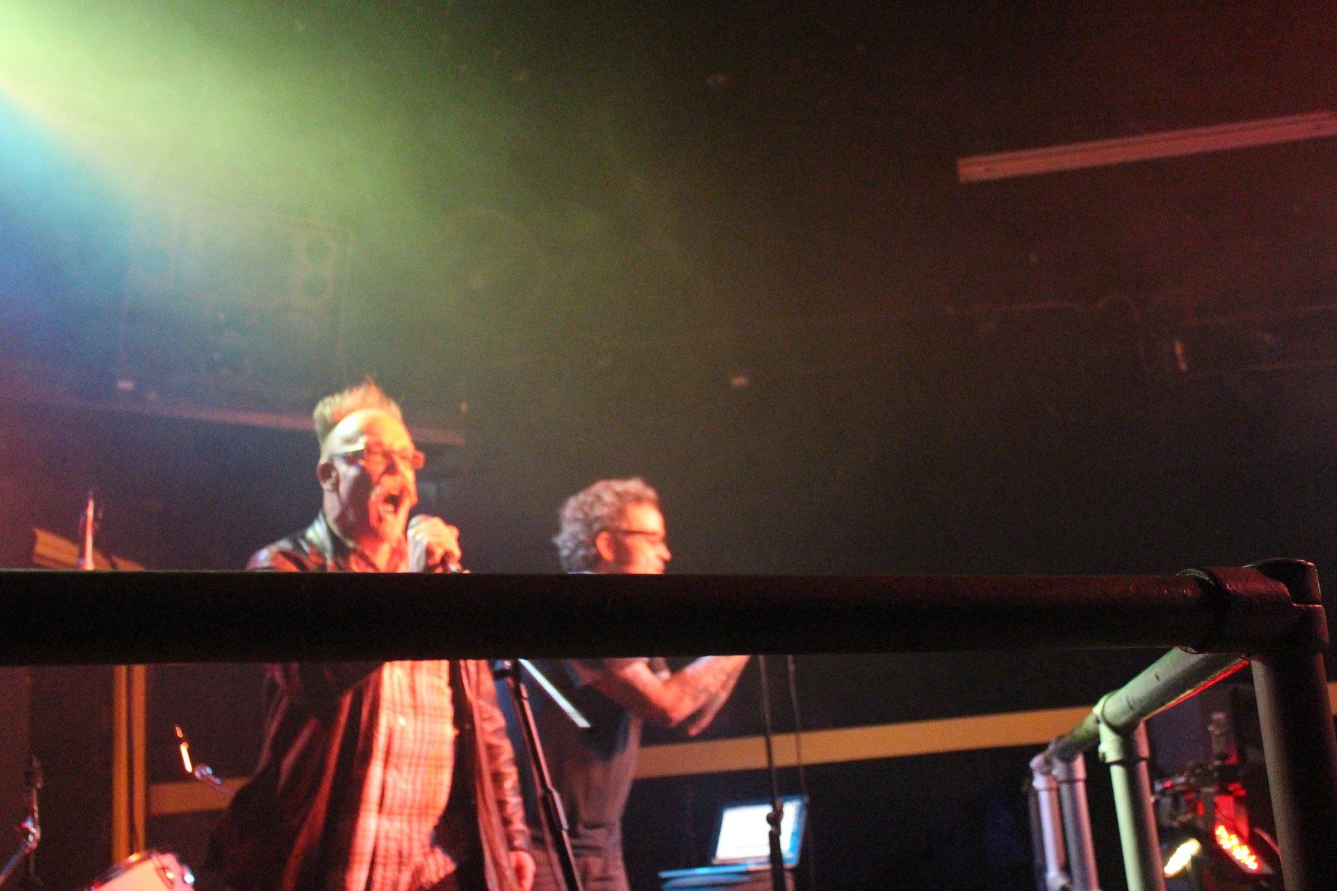 A man singing into a microphone on a stage