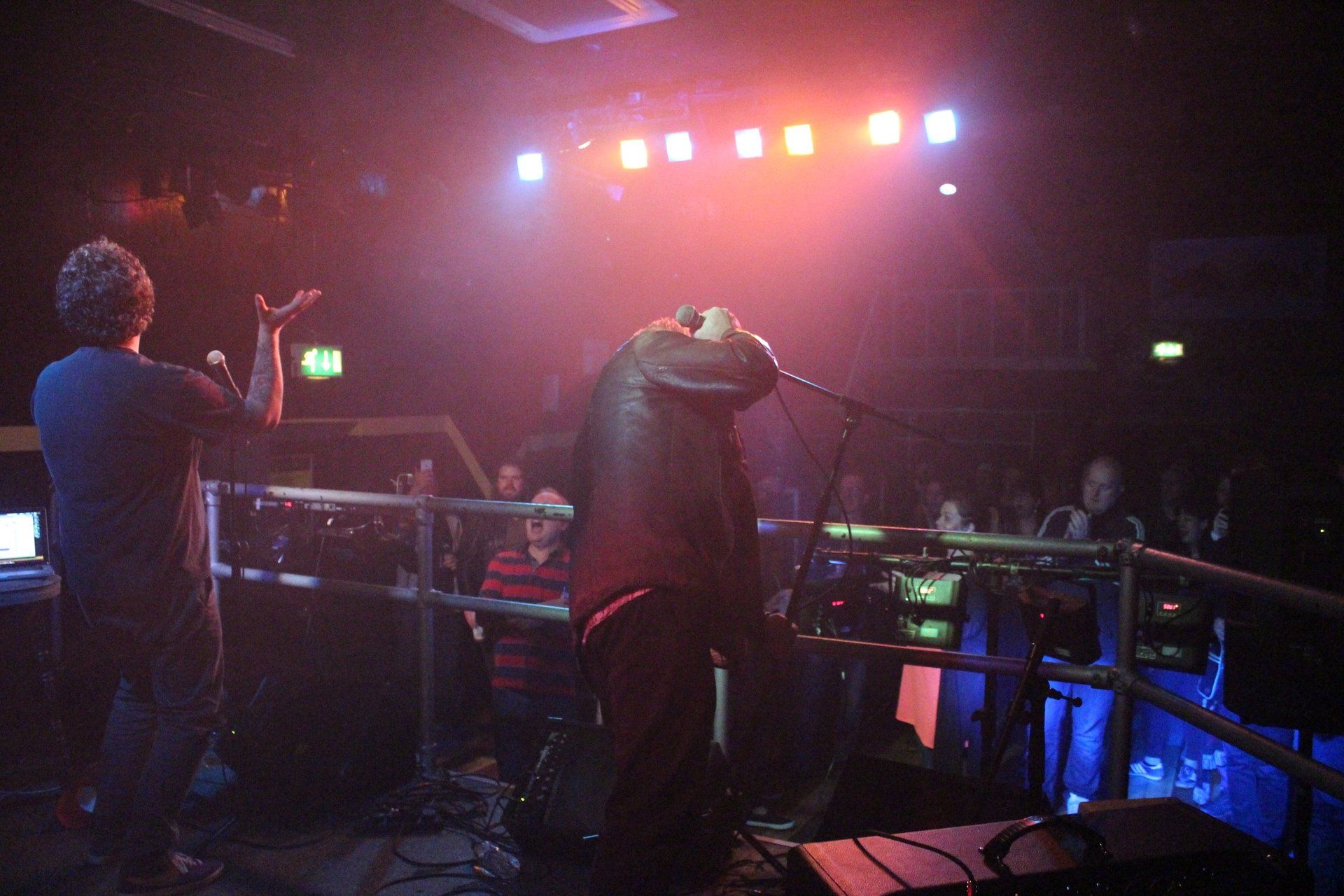A man singing into a microphone in front of a crowd
