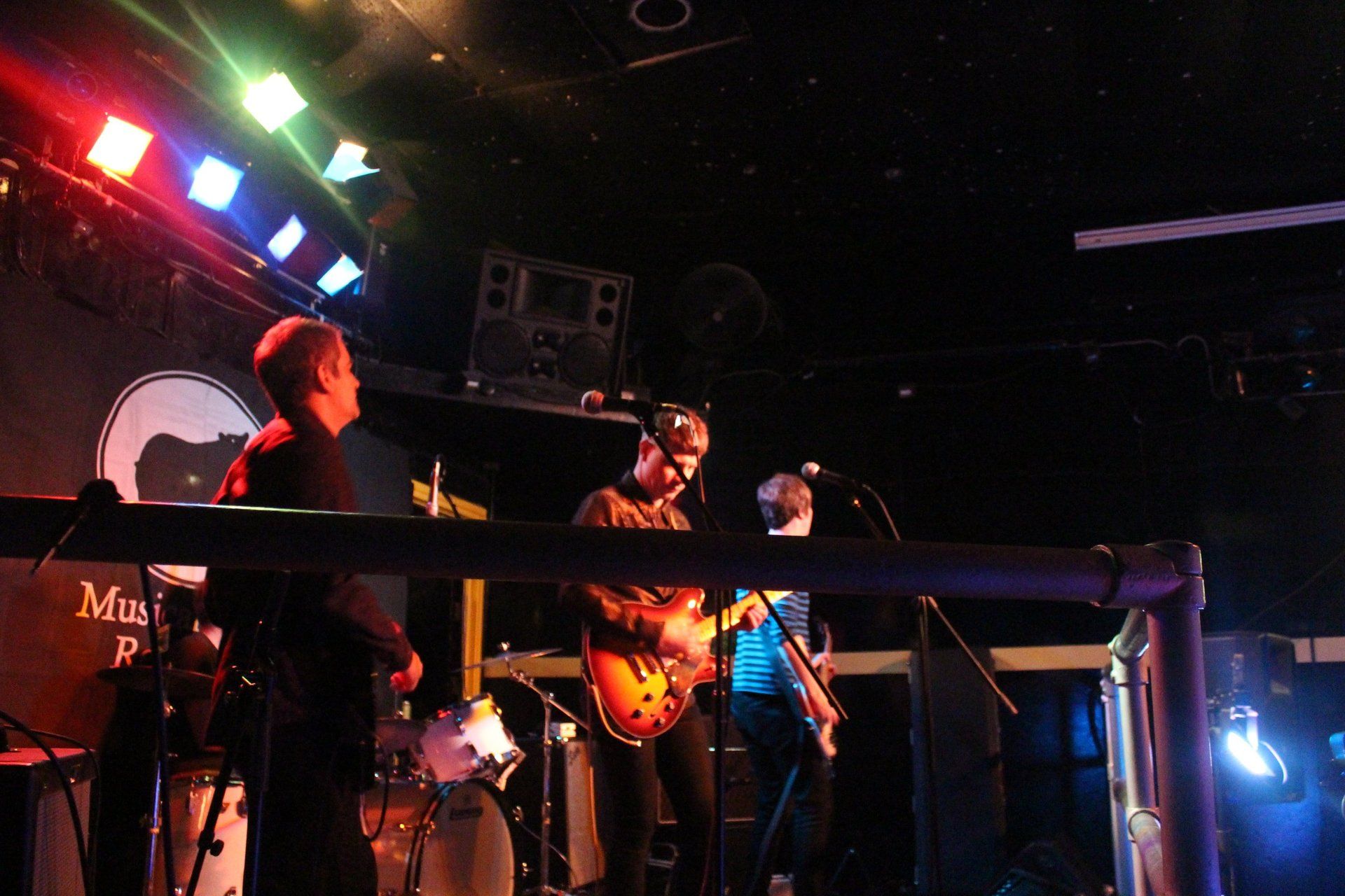 A man playing a guitar in front of a marshall amp