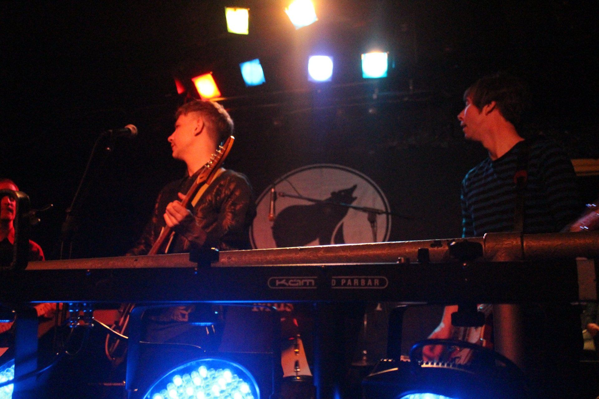 A man is playing a keyboard in a dark room