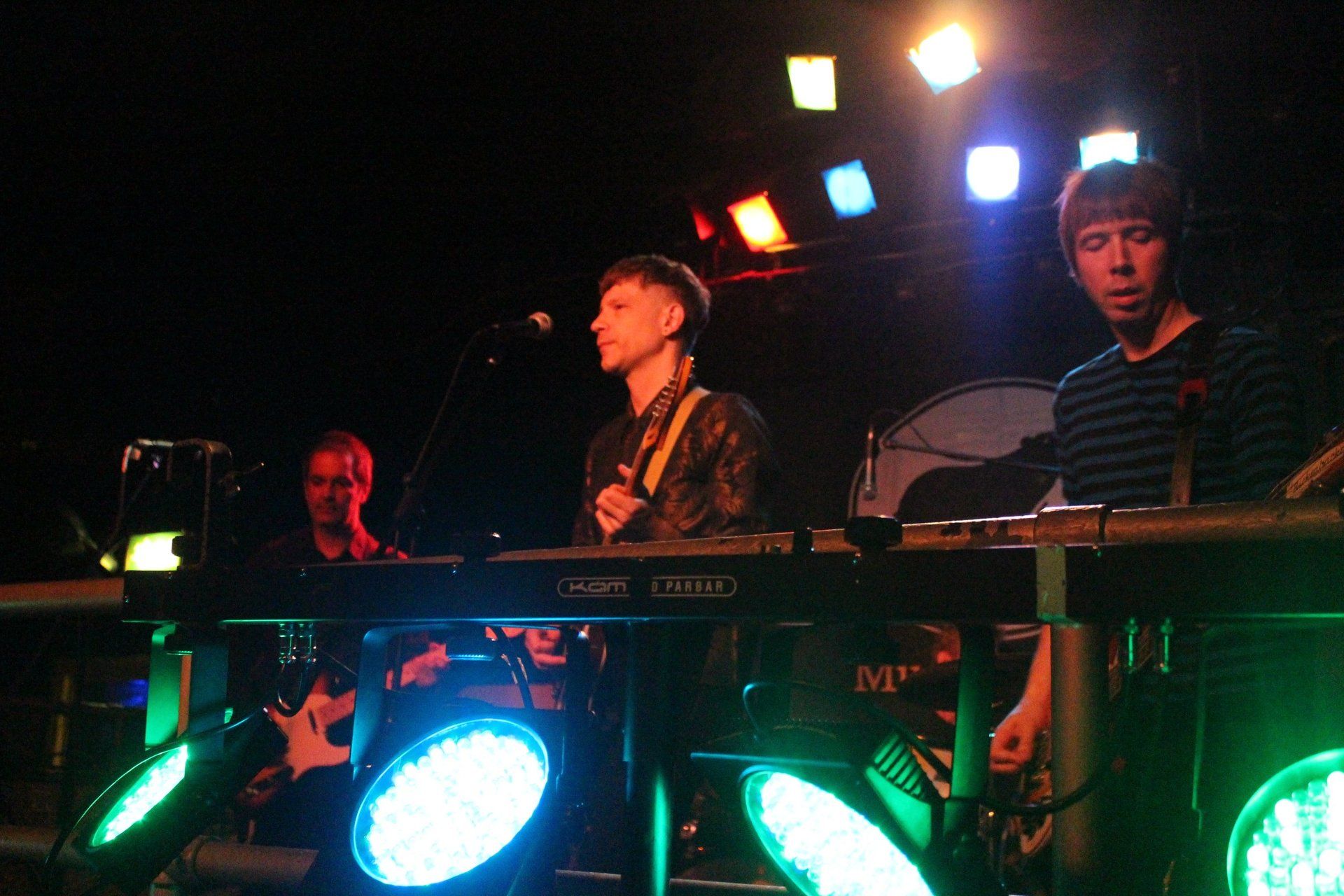 A man is playing a keyboard in a dark room