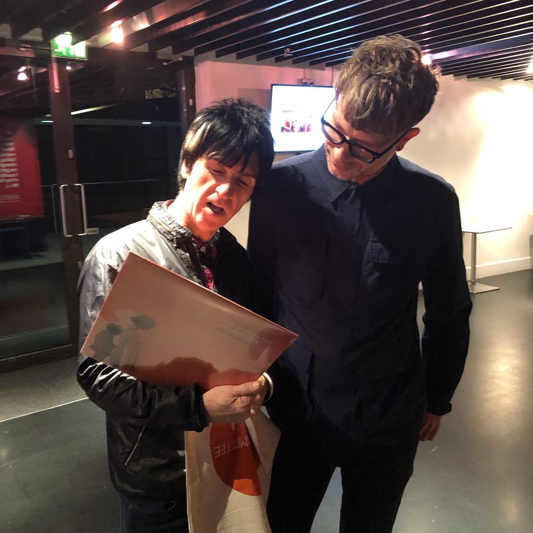 A man and a woman are looking at a piece of paper