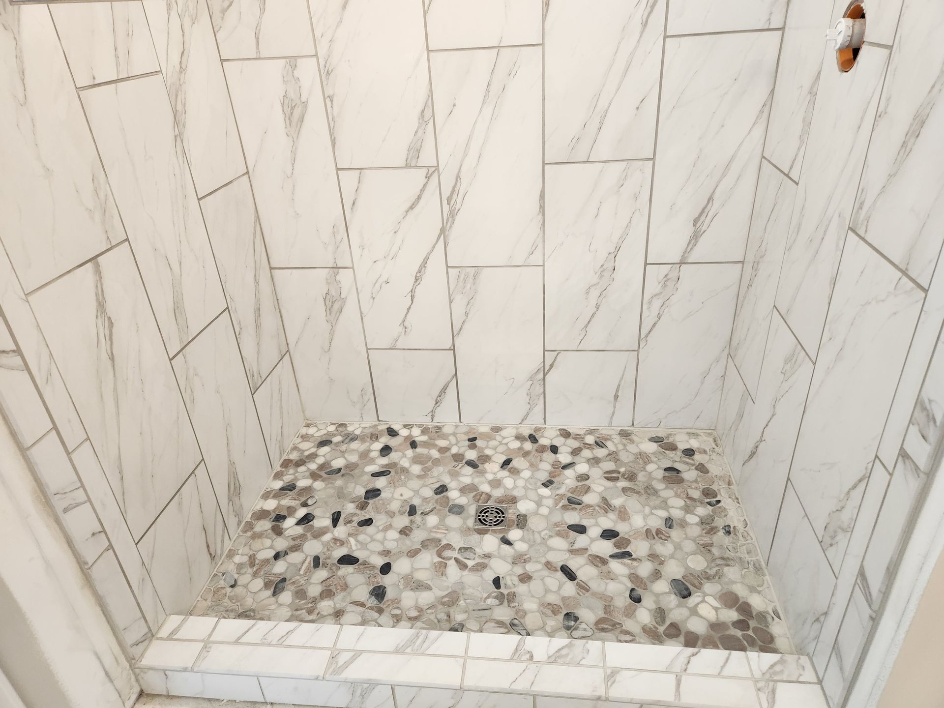 A picture of a mosaic flooring design by cornerstone covering