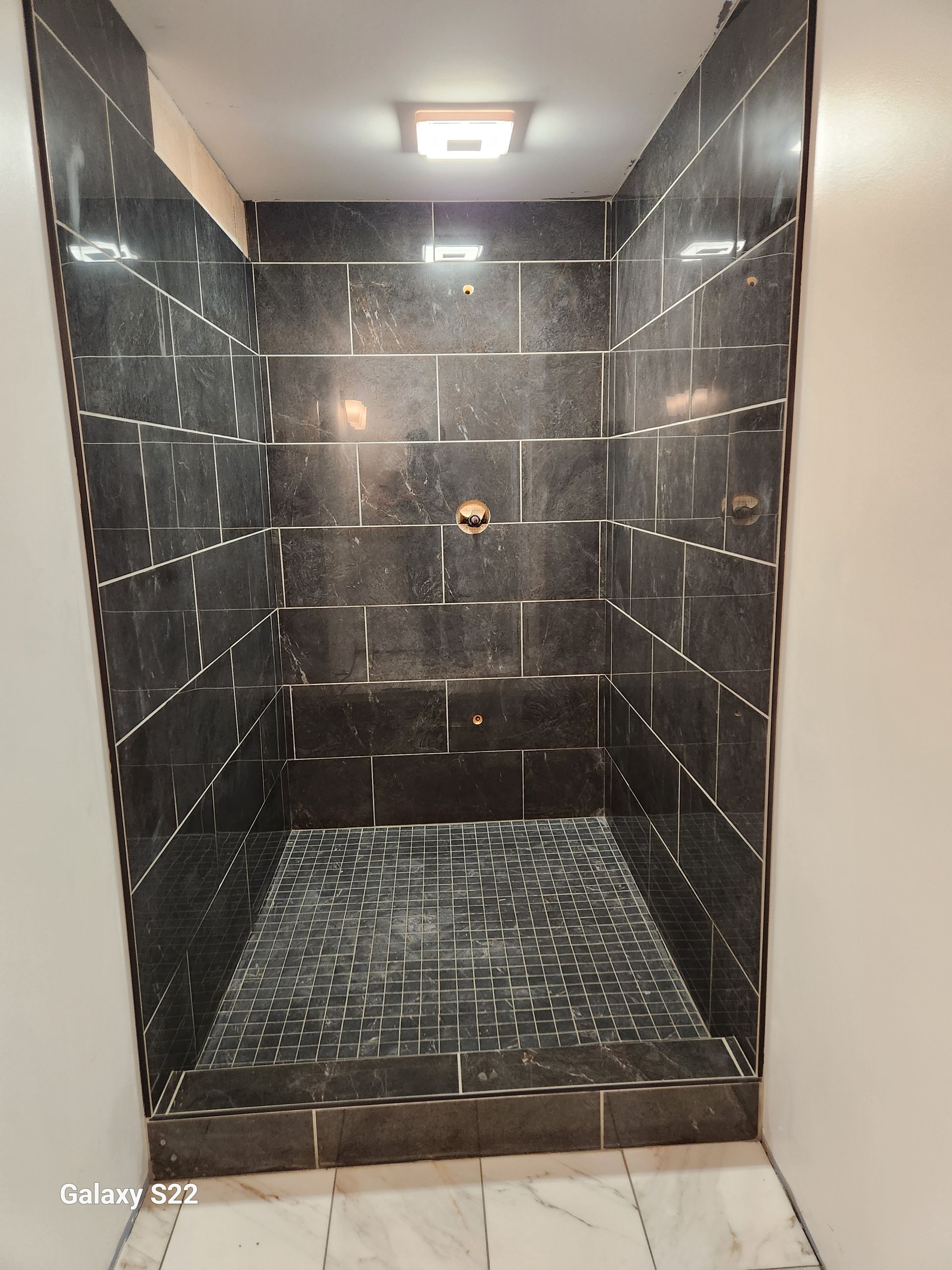 A man is setting up a tile.