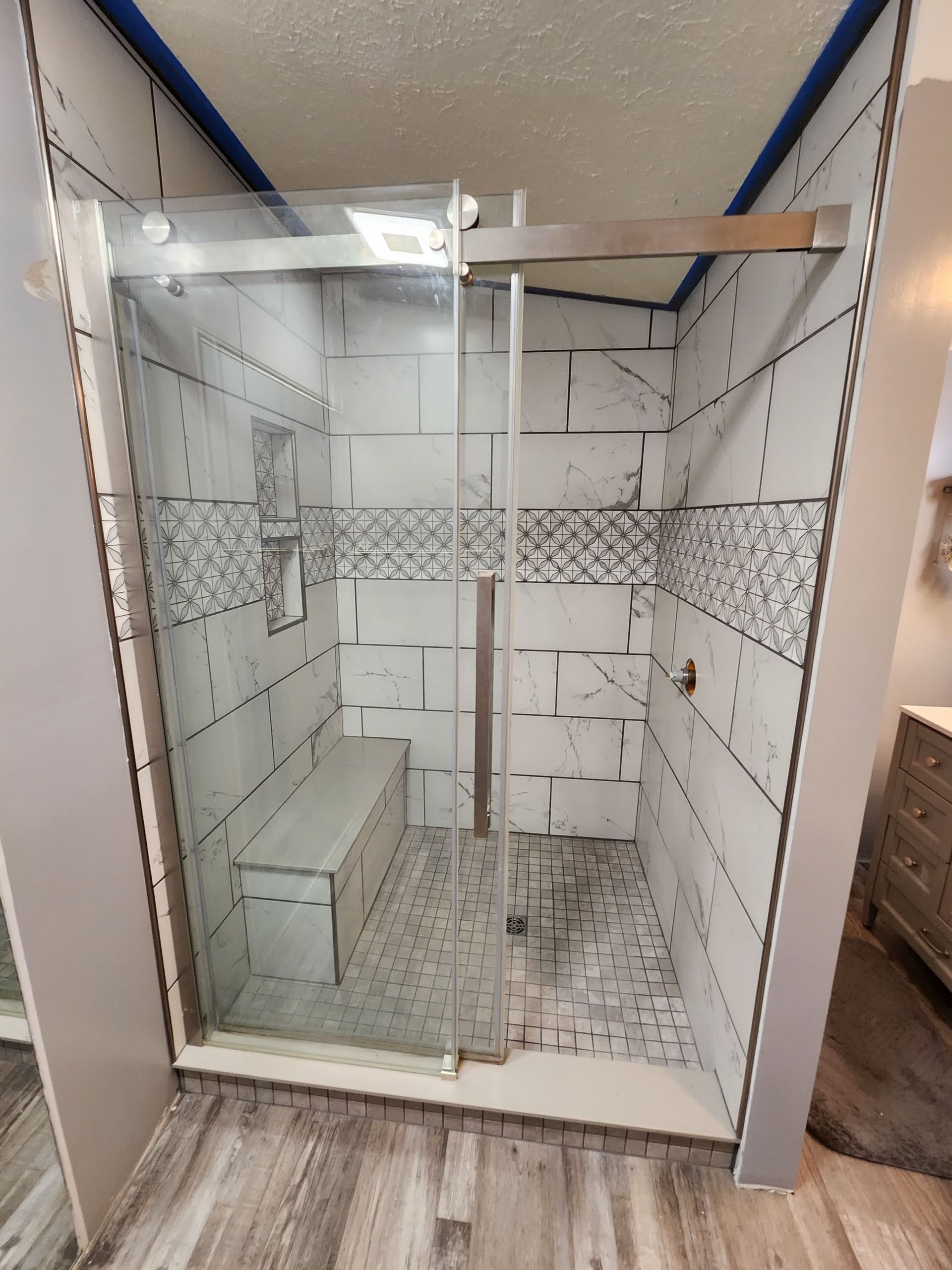 A man is laying a tile floor in a room.