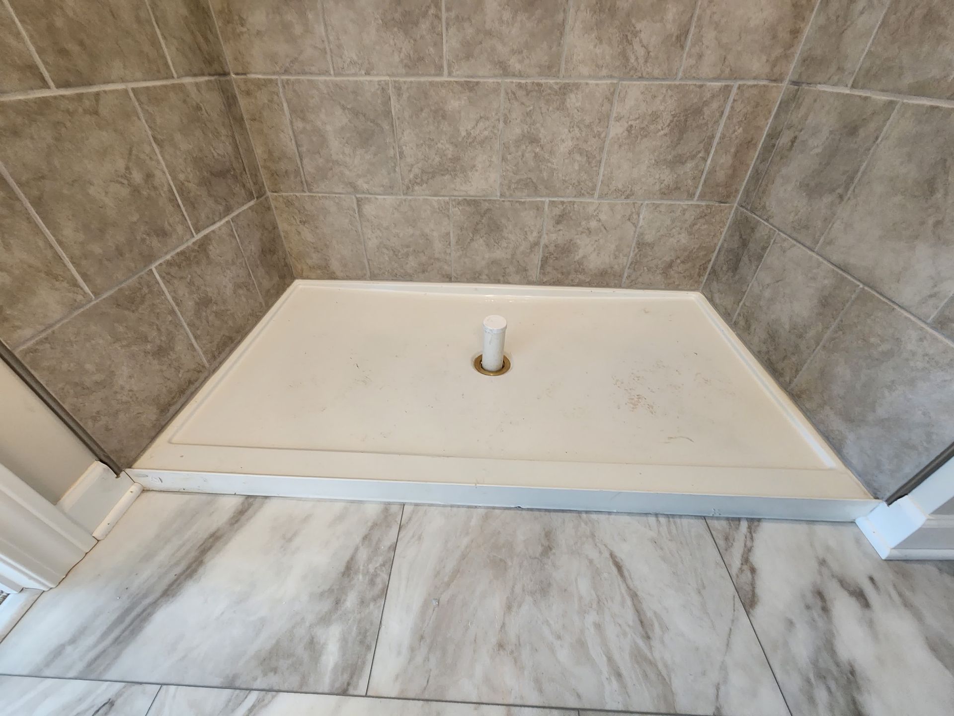 A man is setting up a tile.