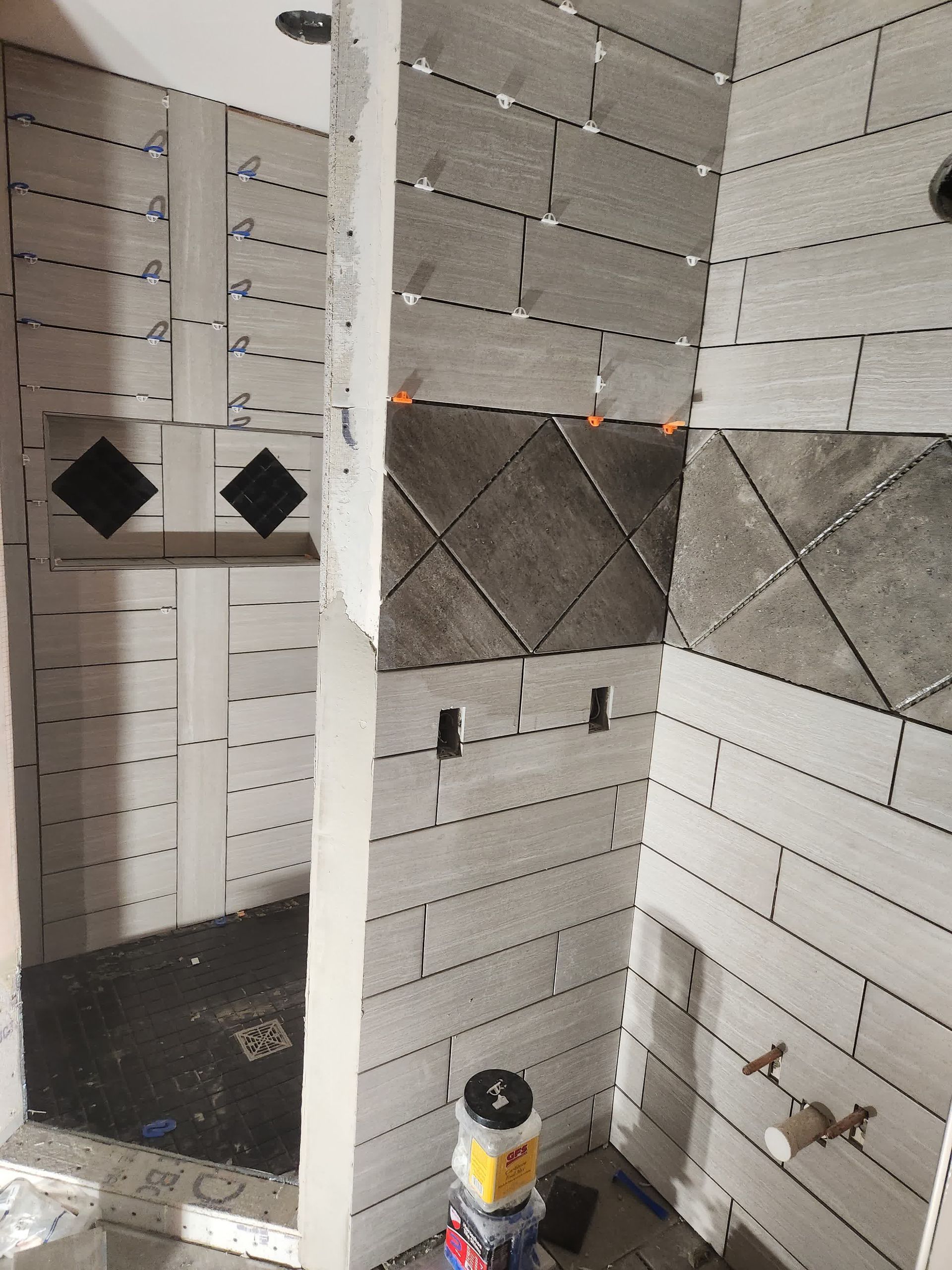 A man is setting up a tile.