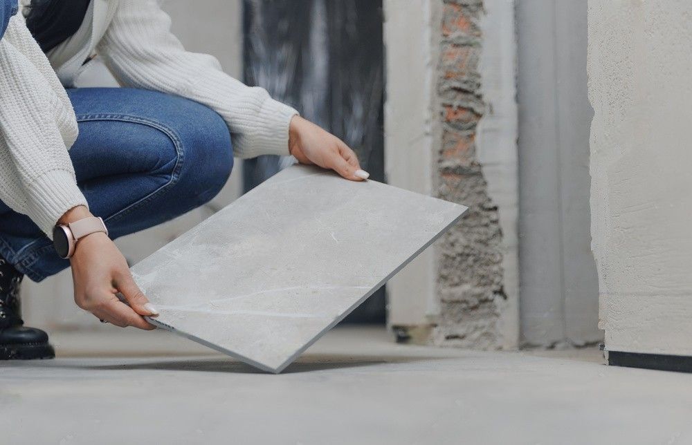 A man is setting up a tile.