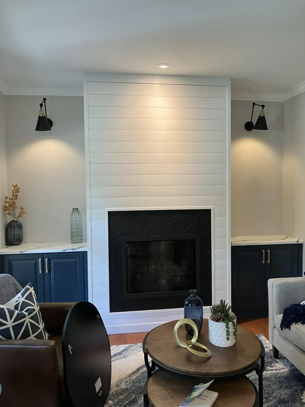 There is a fireplace in the middle of the living room.