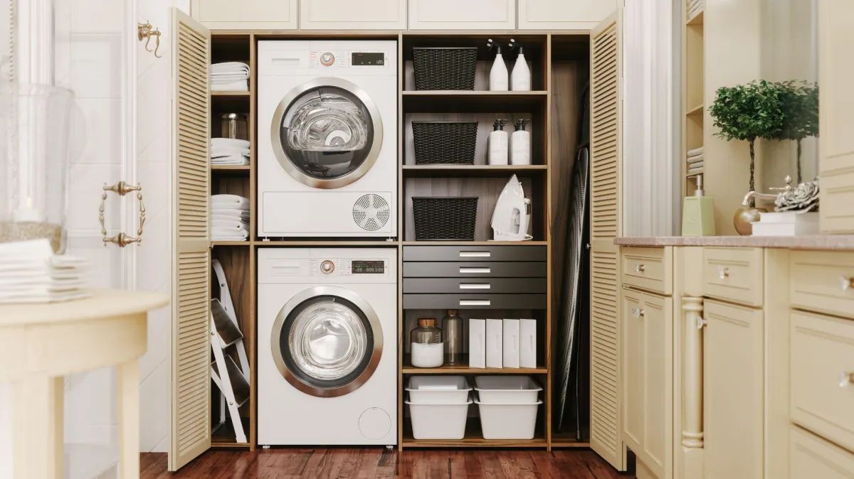 Modern laundry room with stacked washer/dryer cabinets and built-in shelving.