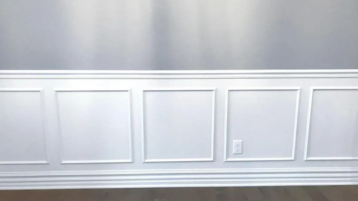 Custom wainscoting paneling in a modern room, showcasing elegant wall detailing.