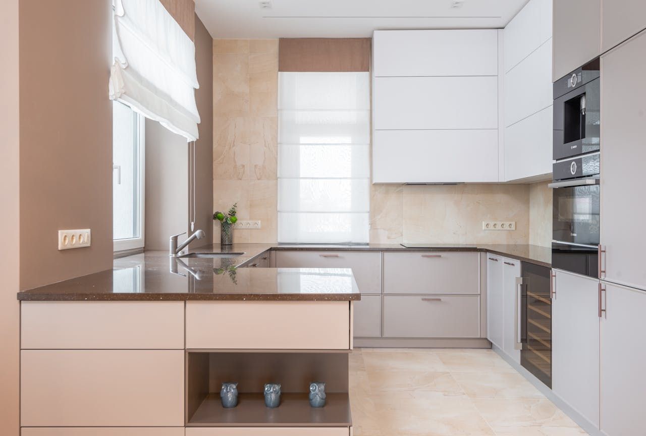 A kitchen with white cabinets and a granite counter top.