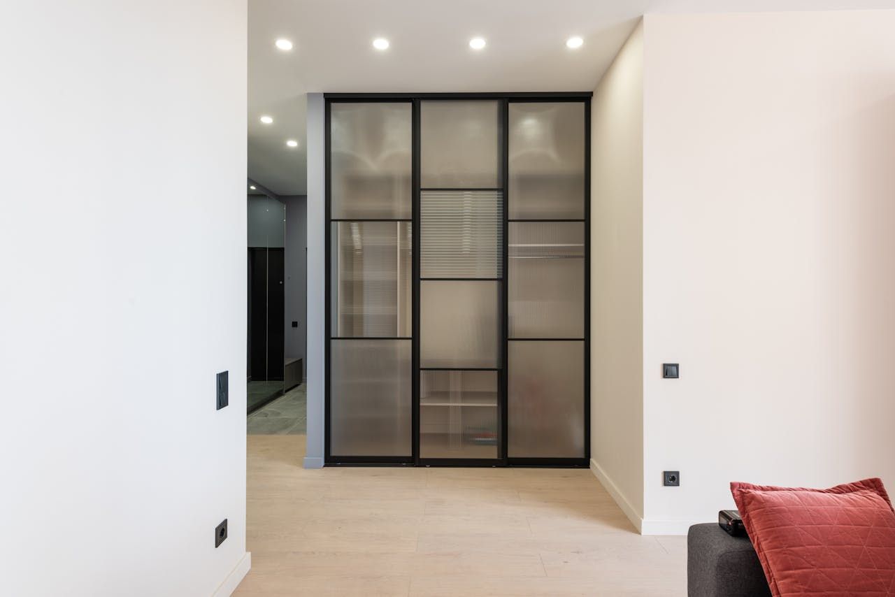 A living room with a sliding glass door and a couch.