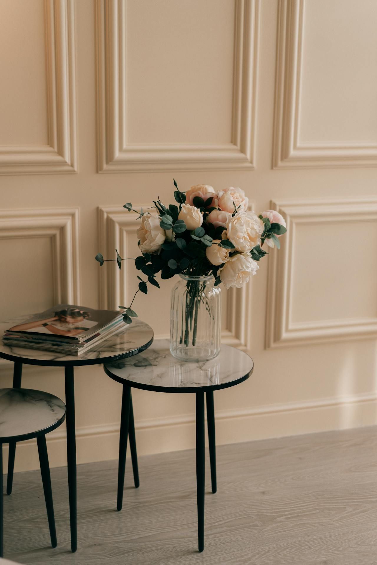 A vase of flowers is sitting on a table in a living room.
