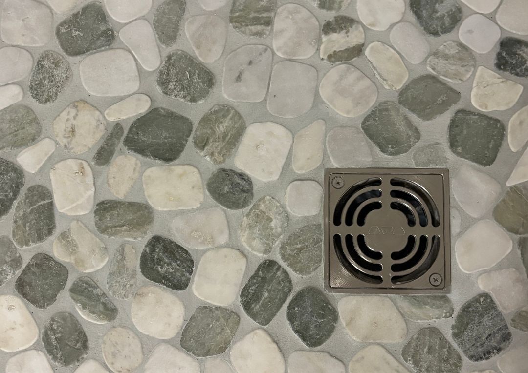 stone pebble flooring in custom shower