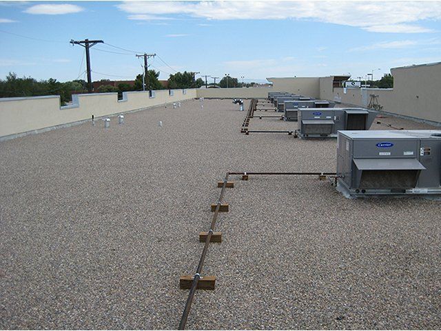 A roof with a lot of air conditioners on it