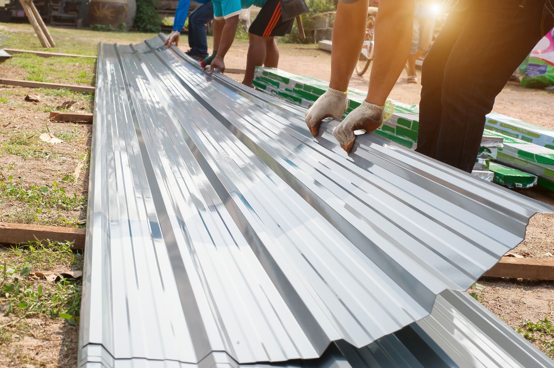 A group of people are working on a metal roof.