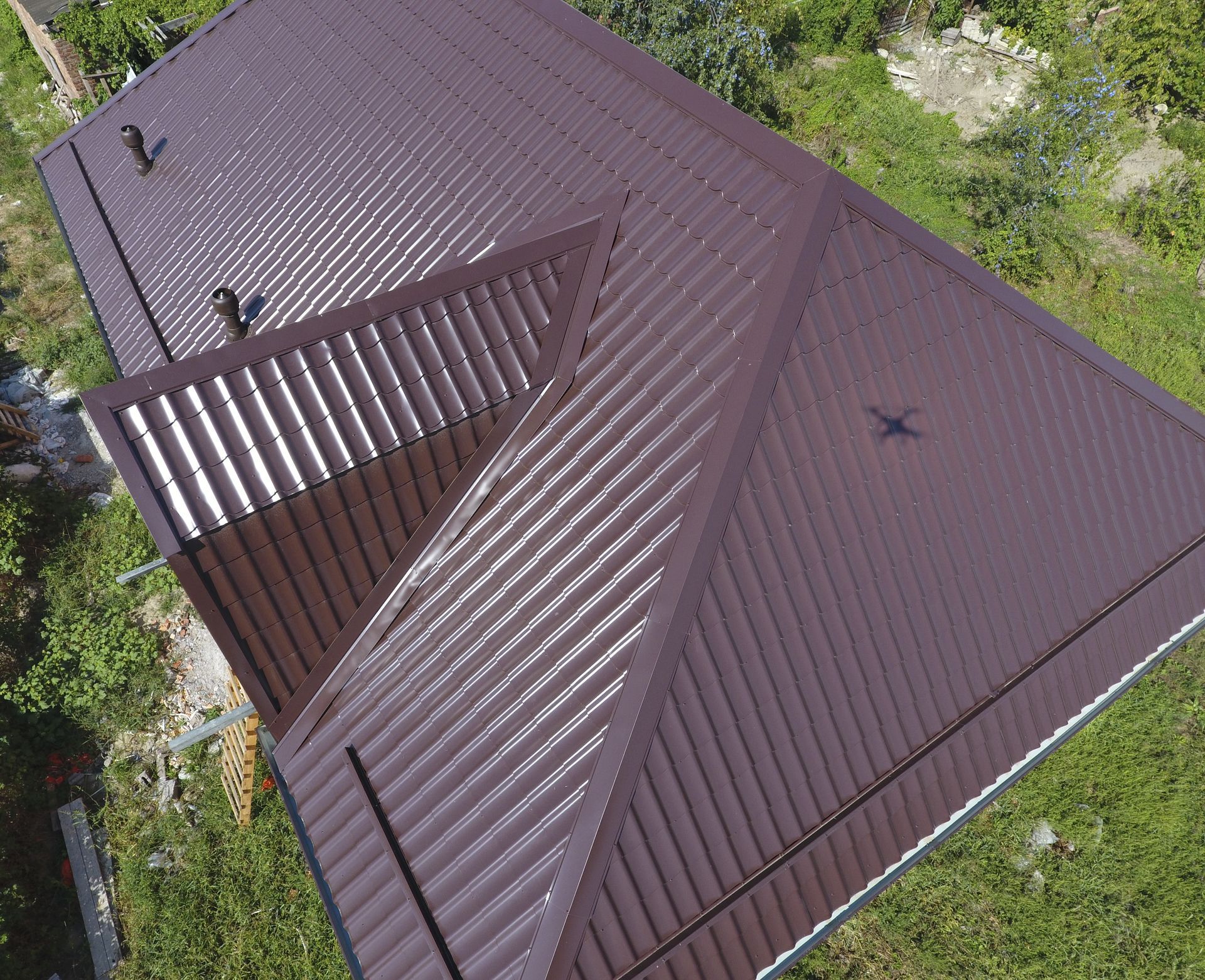 An aerial view of a brown roof with a bird on it