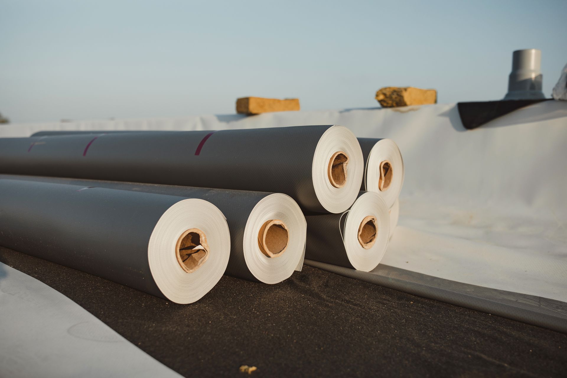 A bunch of rolls of paper are stacked on top of each other.