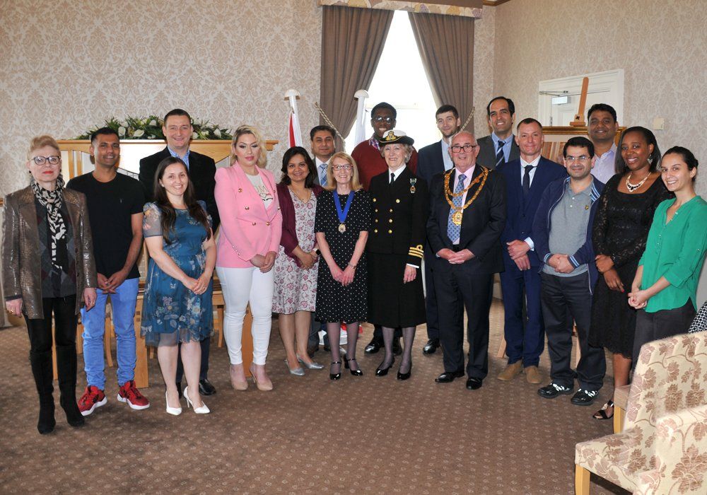 A group of people are posing for a picture in a room.