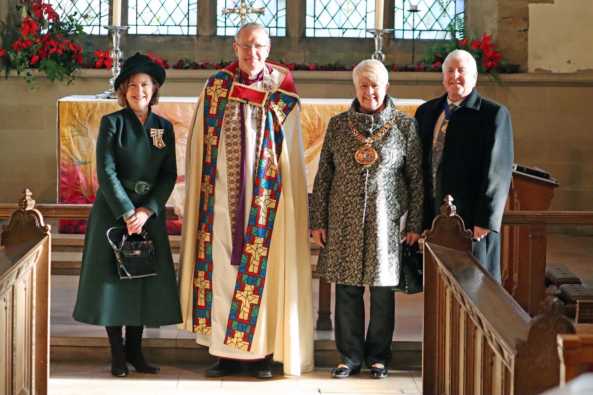 A group of people standing in front of an altar in a church