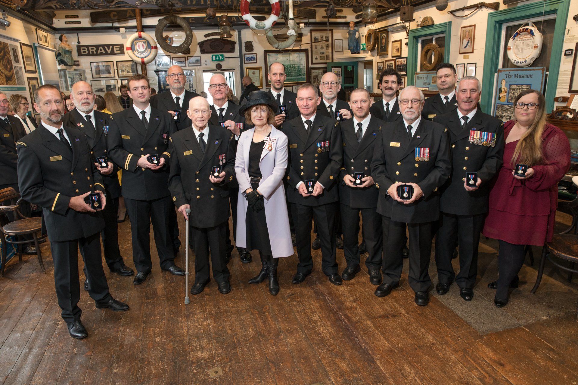A group of people in military uniforms are posing for a picture