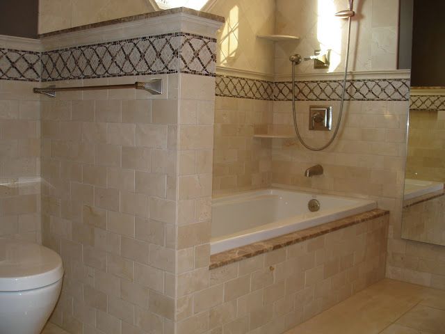 A kitchen under construction with wooden cabinets and a yellow level.