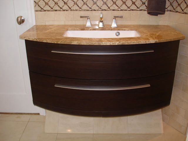 A man is painting a wall in a living room.