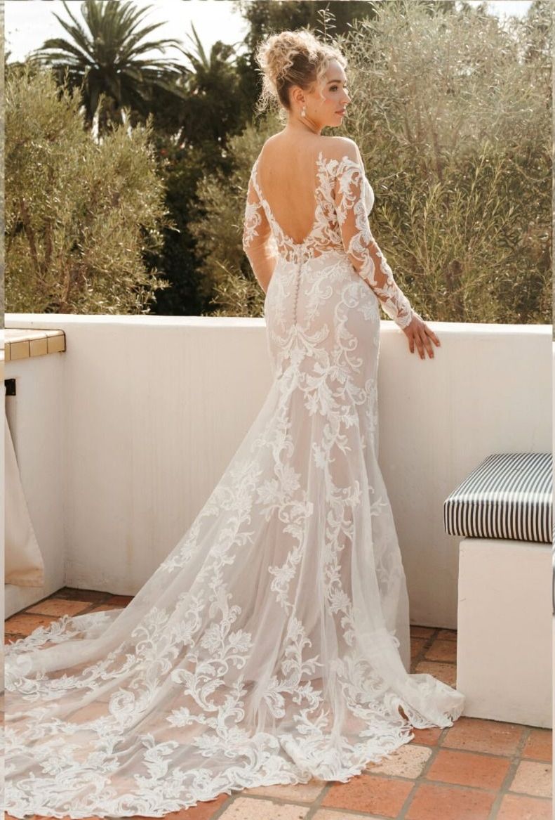A woman in a wedding dress is standing on a balcony.