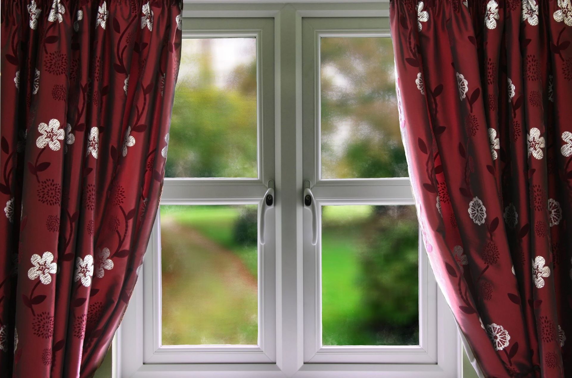 casement window with red curtains