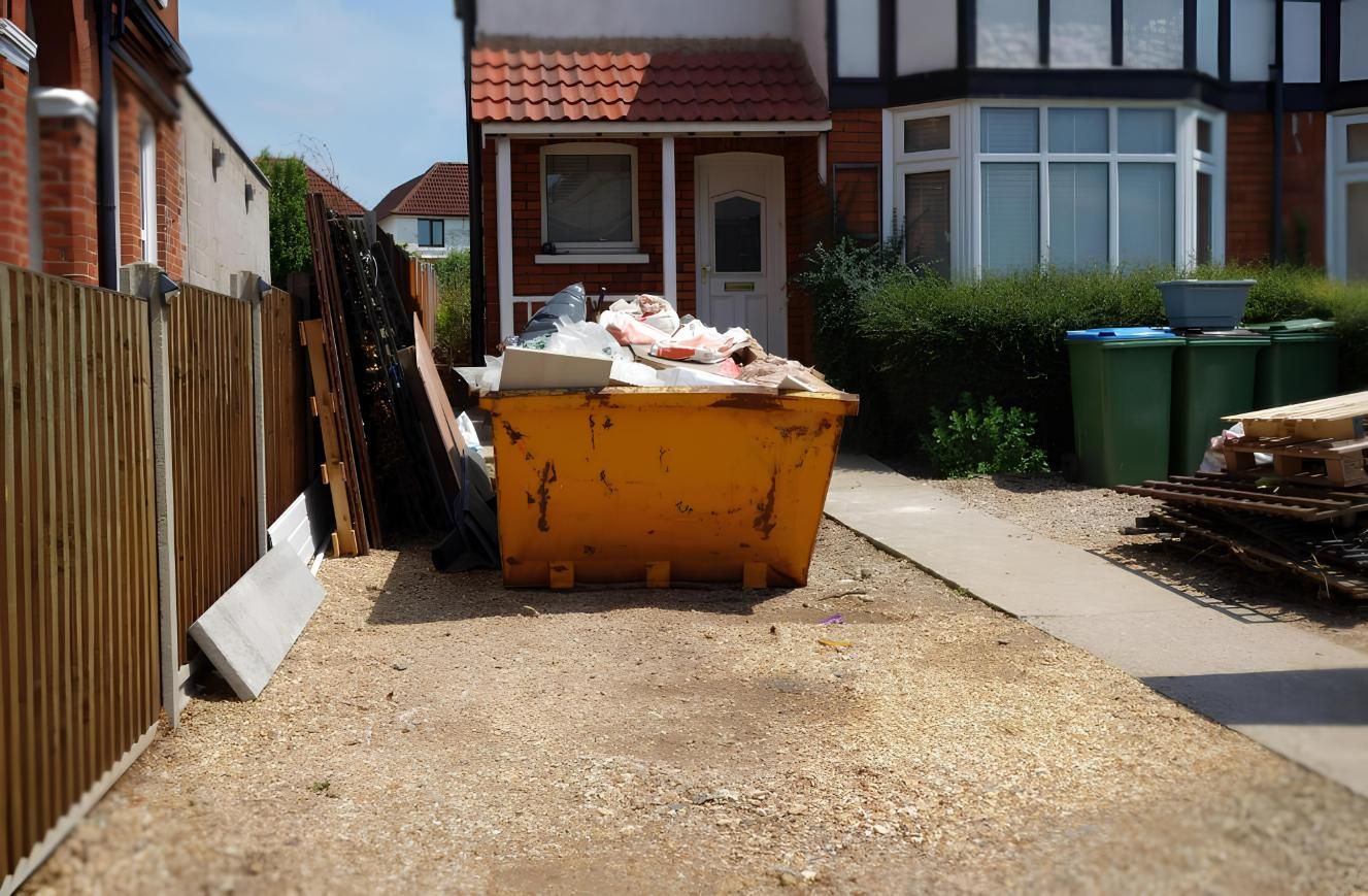 A Yellow Dumpster is Sitting in Front of a House — IBS Skip Bins in Beerwah, QLD