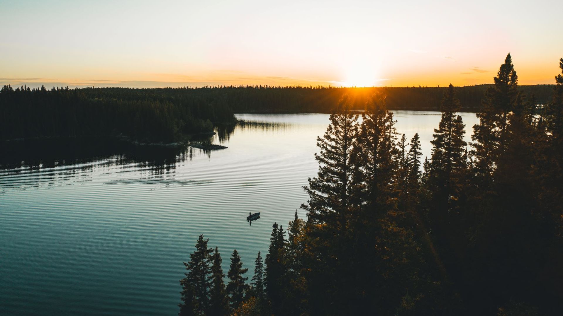 an aerial view of a marina on a lake with boats docked .