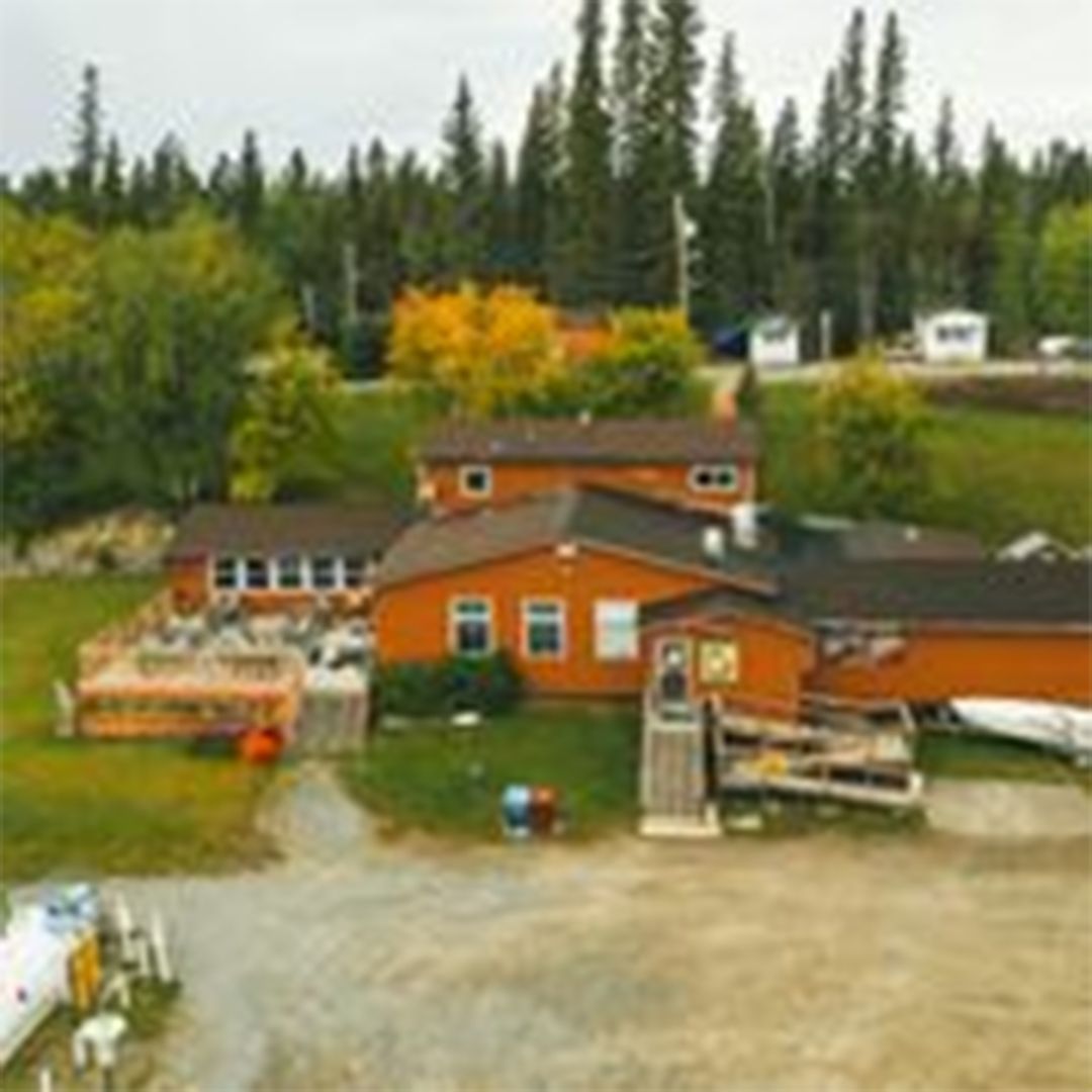 an aerial view of a house surrounded by trees