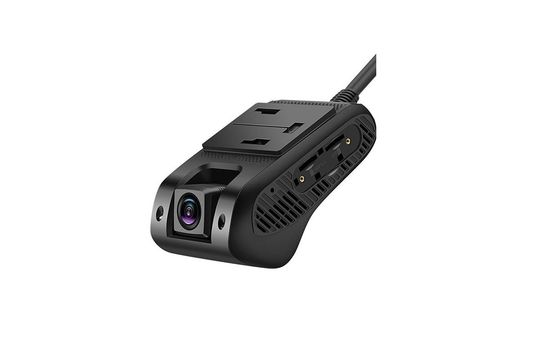 A man is driving a car with a tablet on the dashboard.