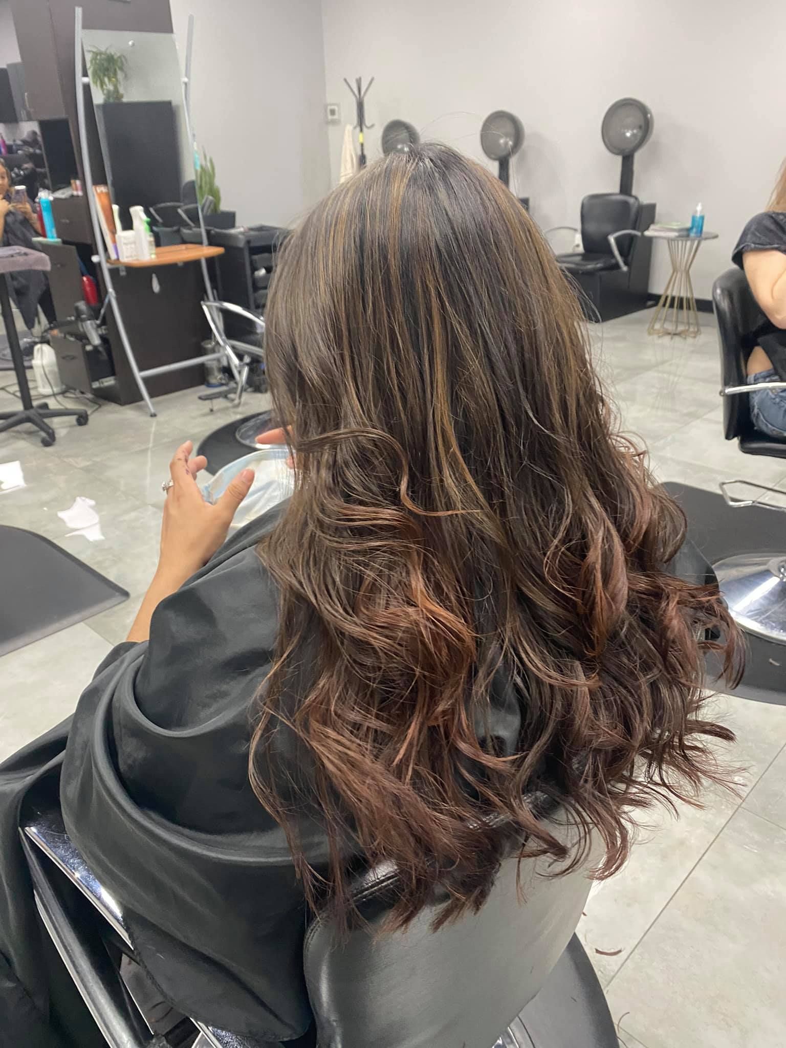 A woman is getting her hair done at a salon.