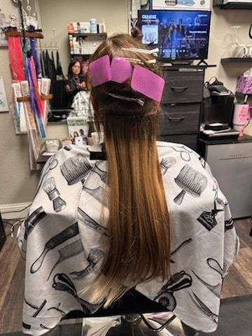 A man is getting his hair cut at a barber shop