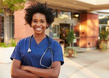 Family Physician — Female Doctor Standing Outside Hospital in Richmond, VA