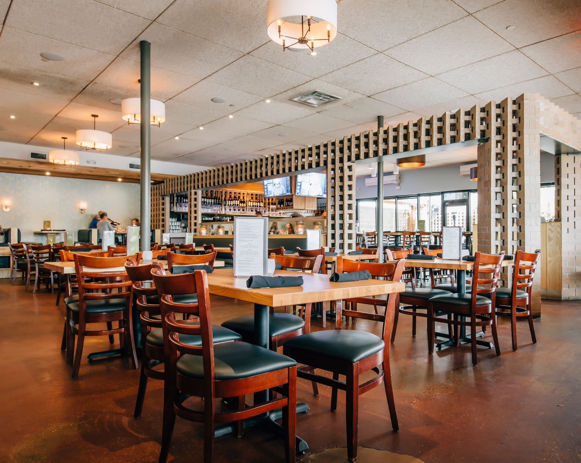There are many tables and chairs in the restaurant.
