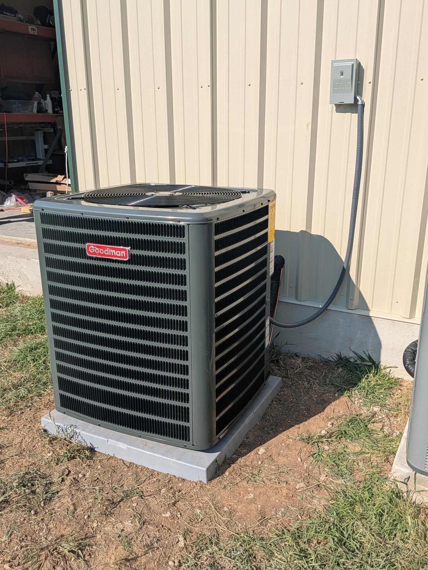 Goodman air conditioning unit outside a building.