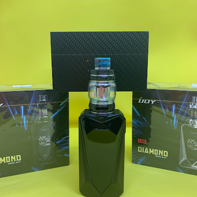 Black vape device with blue accents, sitting in front of two boxes with the same device.