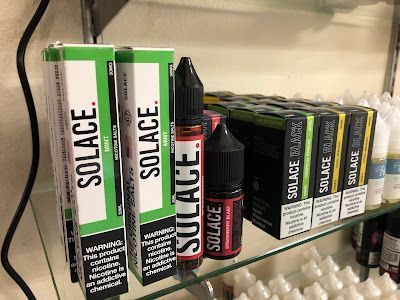 Shelves stocked with SOLACE brand vape juice and boxes, featuring mint and strawberry flavors.