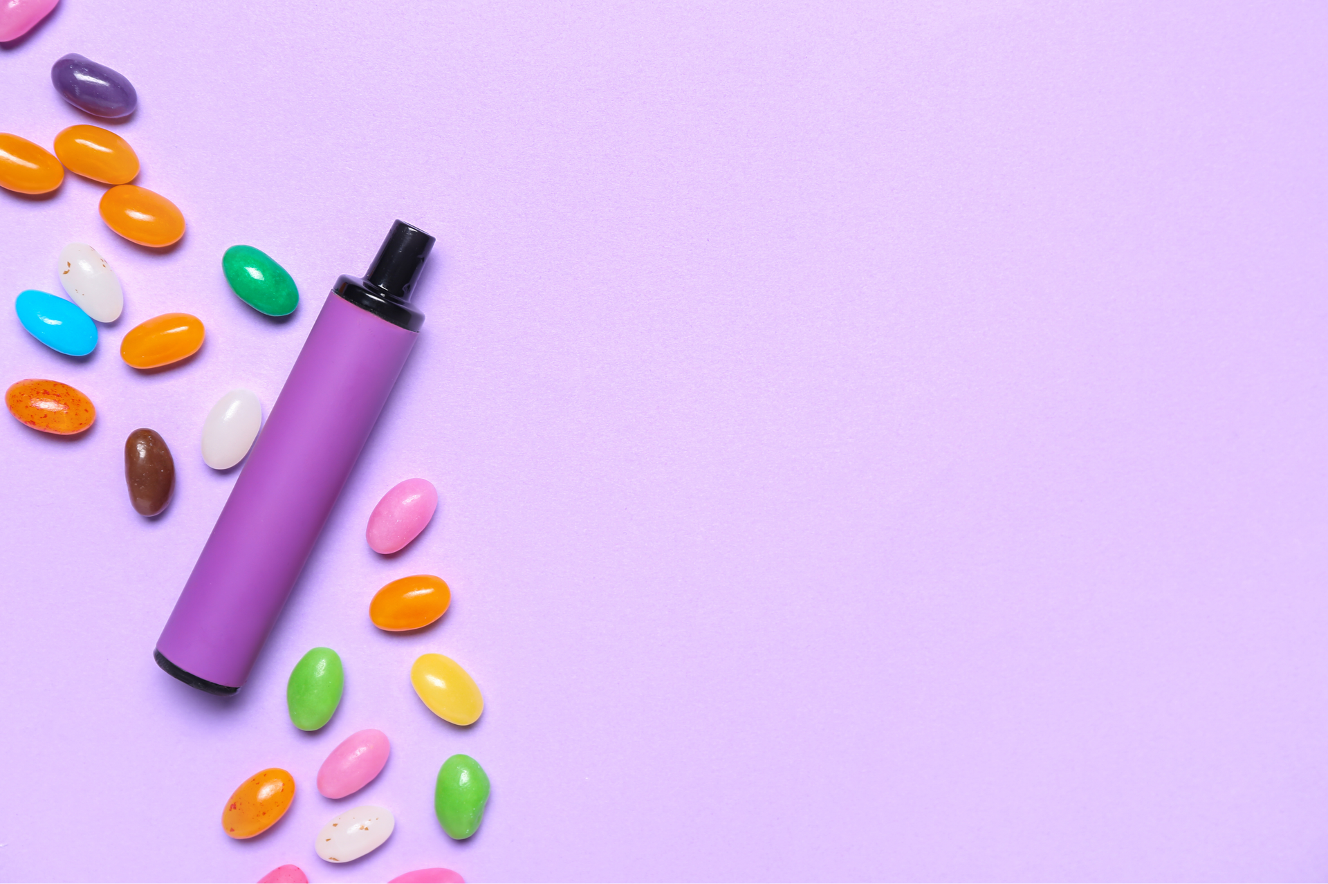 Purple vape pen and colorful jelly beans on a purple background.