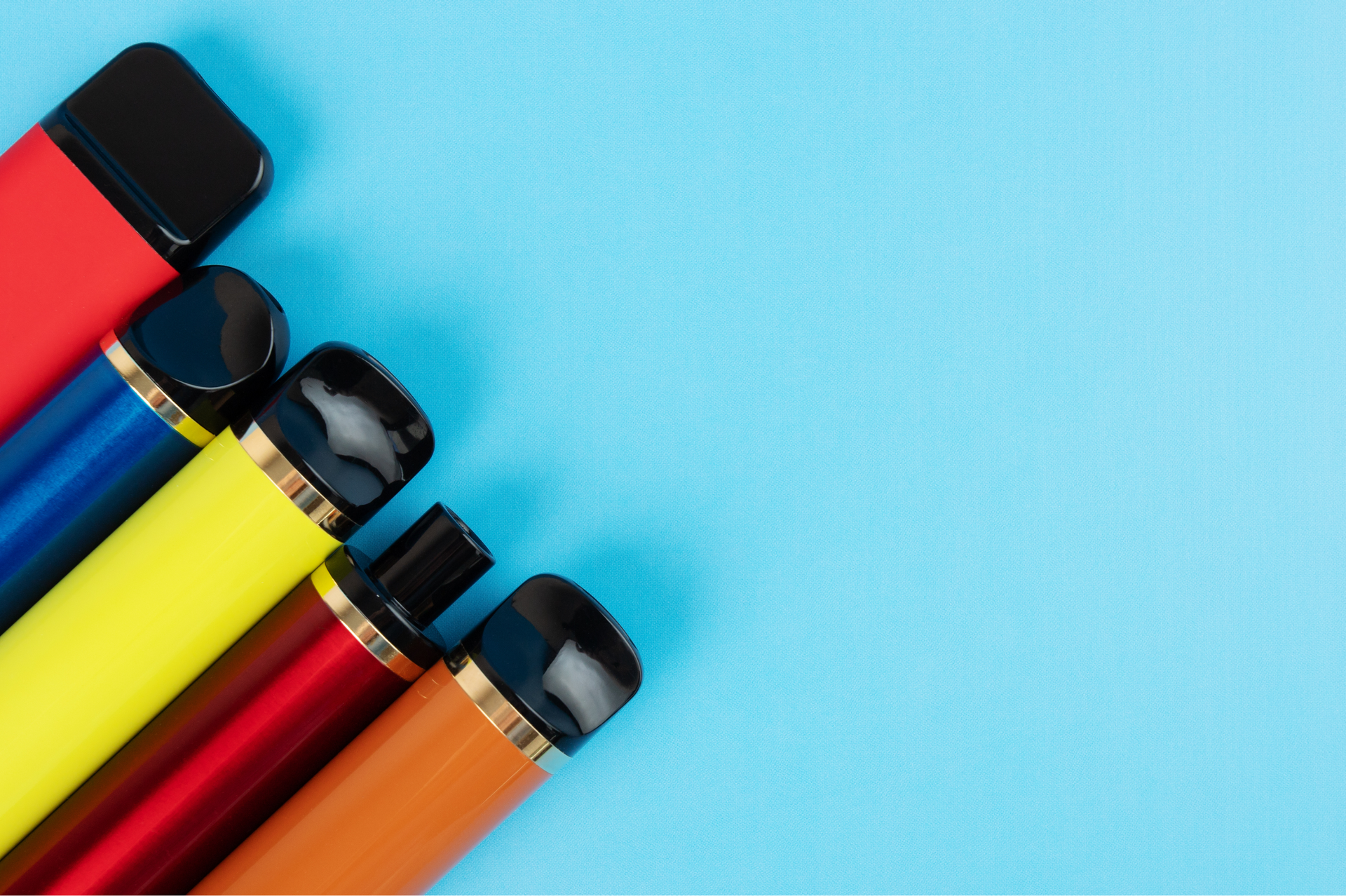 Colorful disposable vapes on a blue background