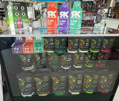 Display case with beverage products, colorful packaging, store setting.