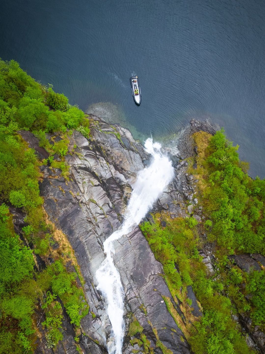 Birdview of RIB boat by a waterfall in Fyksesund